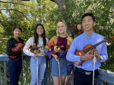 Photo of the Fourtés Violin Quartet (four youth holding their violins)