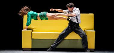 Two dancers mid-performance on a couch