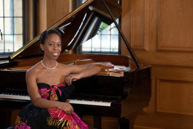 Samantha Ege sits at a piano.