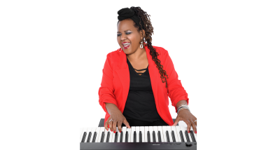 Musician Rita Lackey plays a piano keyboard while singing