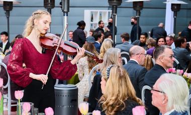 A Colburn Conservatory student performs a serenade on the Colburn Plaza.