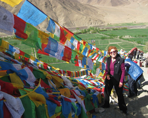 Inveterate world traveler Falvey in Tibet, with prayer flags at Yongbulakang 