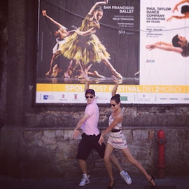 Principal dancers Mathilde Froustey and Pascal Molat pose in front of a Spoleto Festival poster advertising S.F. Ballet