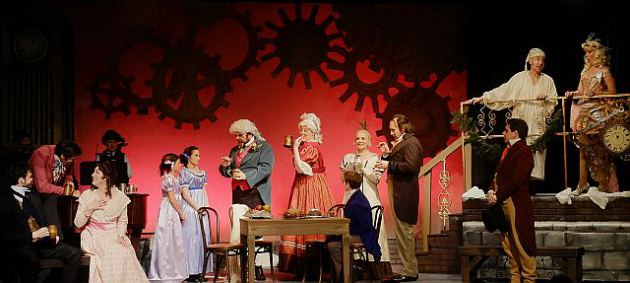 Scrooge (Jason Graae) and the Ghost of Christmas Past (Elise Youssef), standing above the crowd, survey the party in Scrooge in Love! (Photo by Patrick O'Connor)